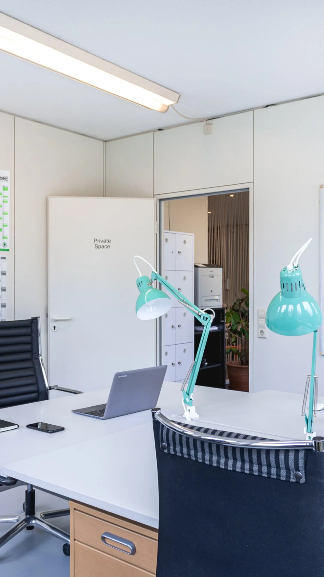 Abgeschlossener Private Space neben zwei Arbeitsplätzen